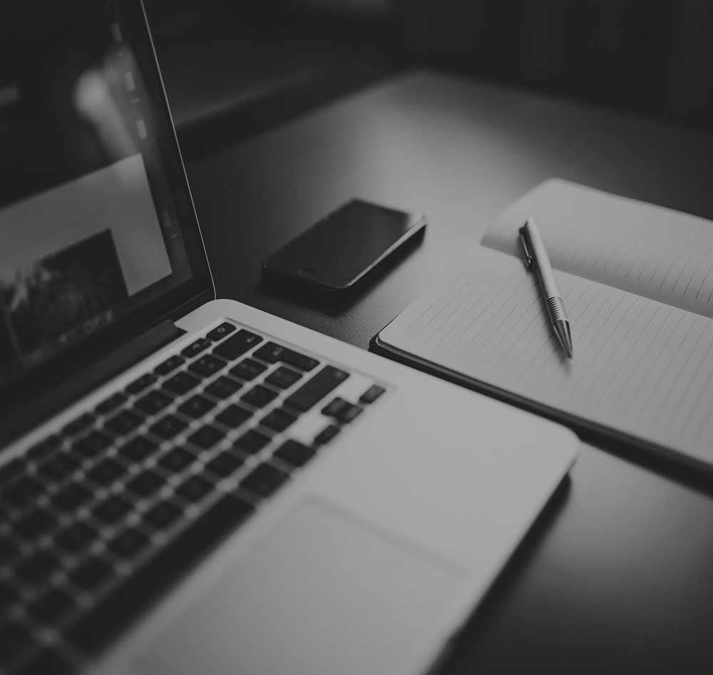 Laptop and notepad being used to work out lowest interest rate and mortgage repayments